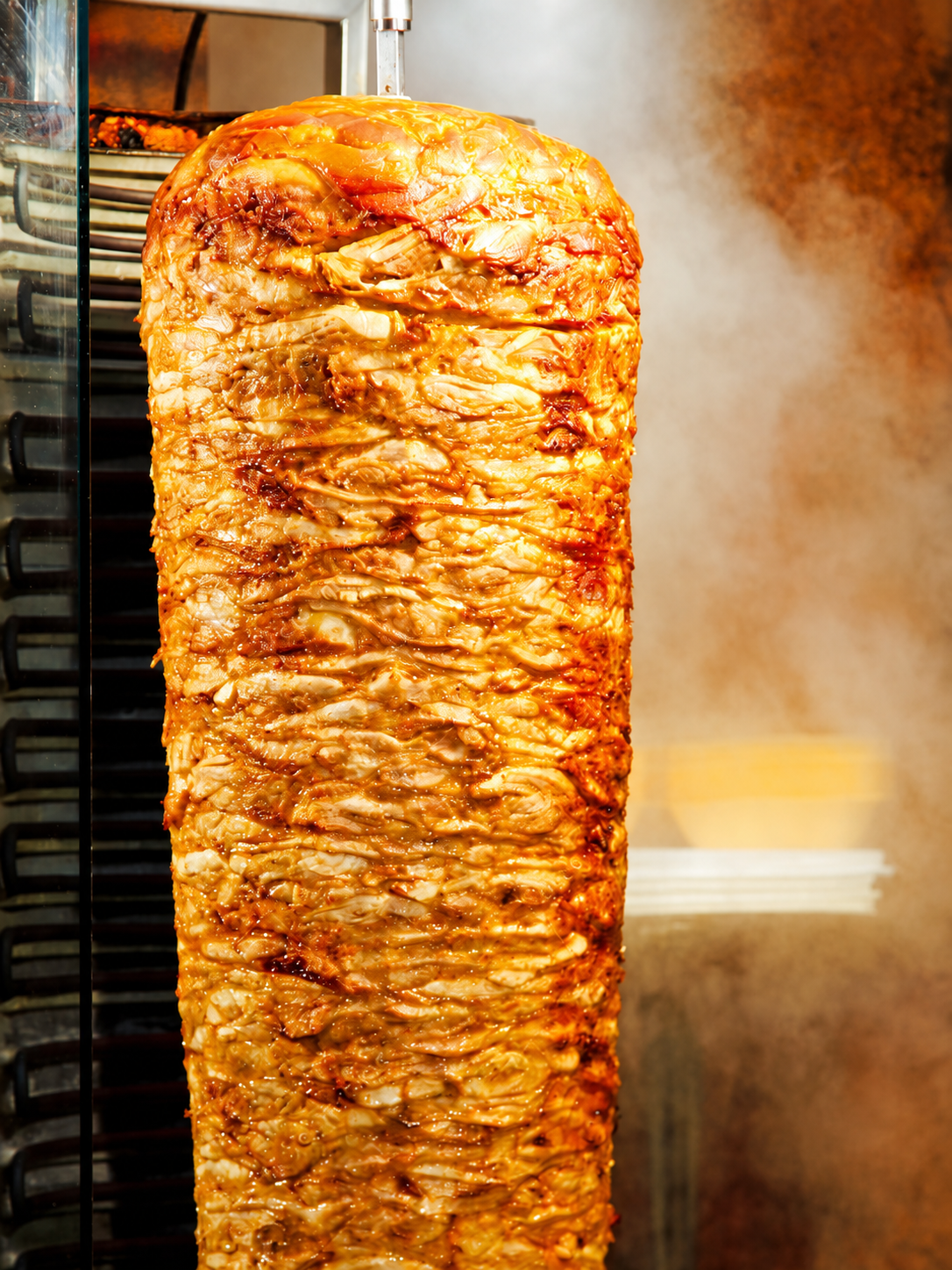 Slow-roasted halal chicken döner on the vertical spit